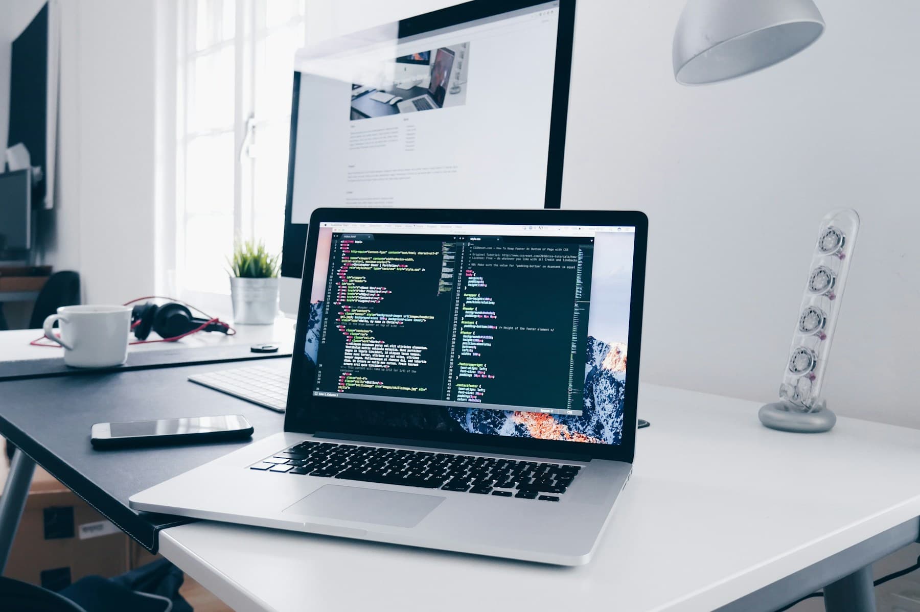 Modern development workspace with code displayed on a laptop